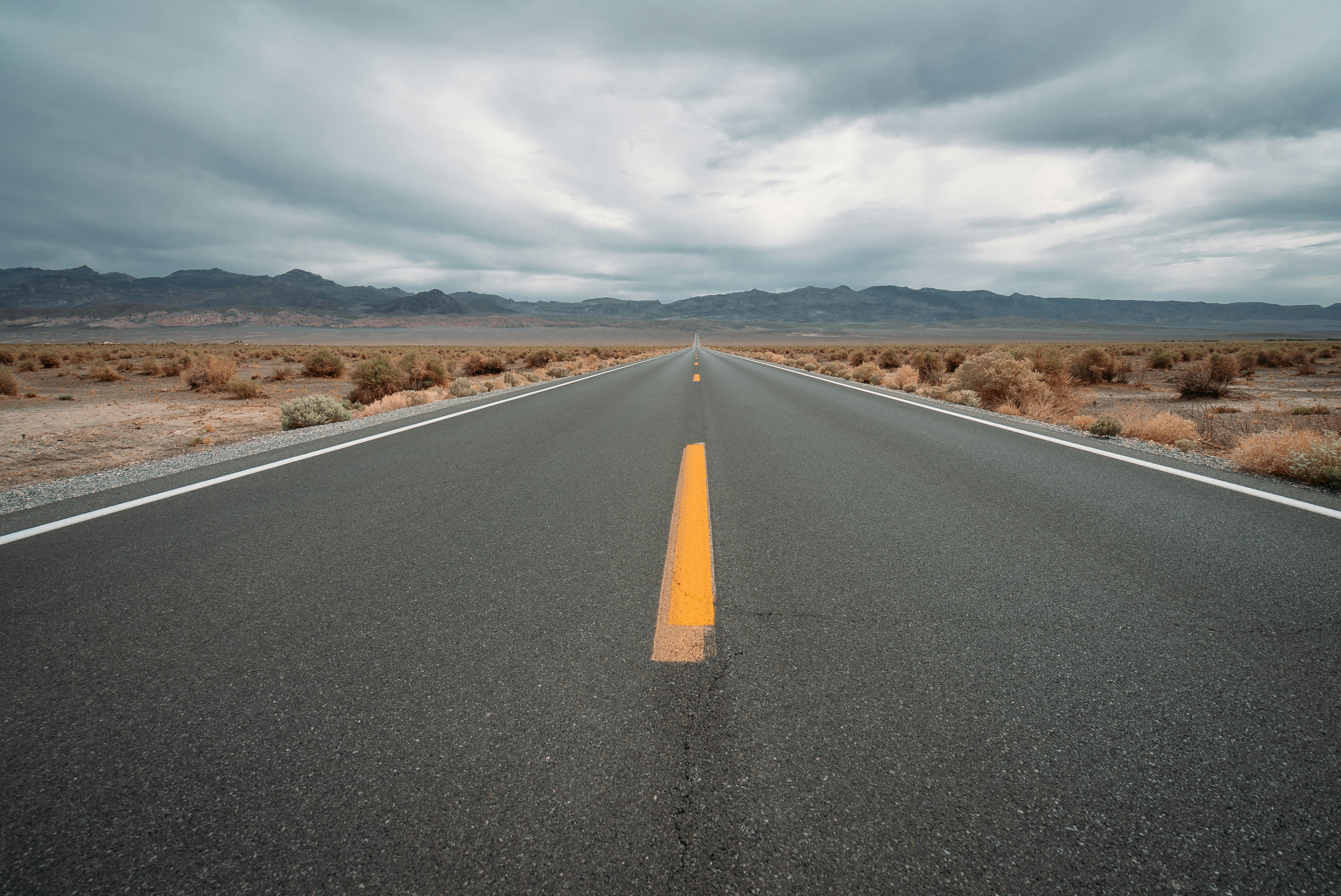 black asphalt road under cloudy sky during daytime